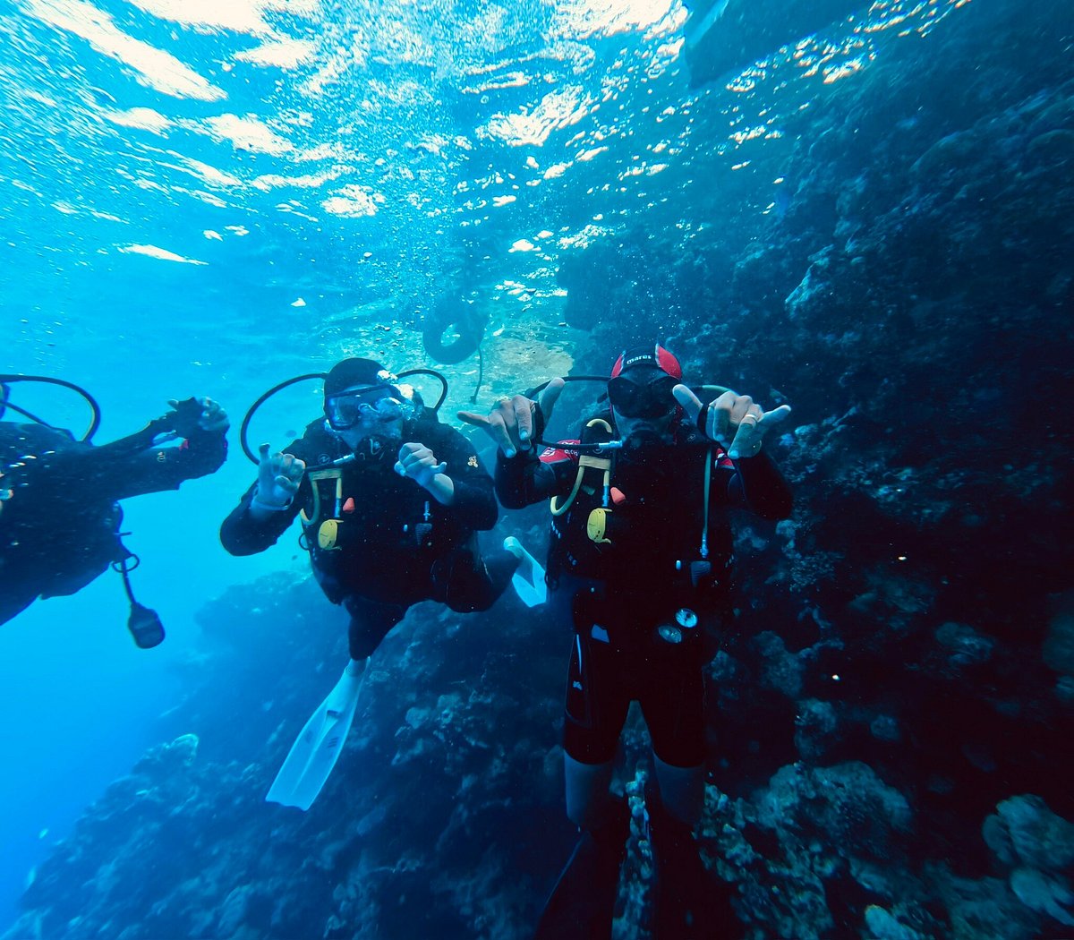 Diver descending through sunlit Red Sea water
